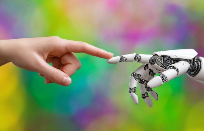 Human hand reaching toward a robotic hand, symbolizing collaboration between human judgment and modern tools