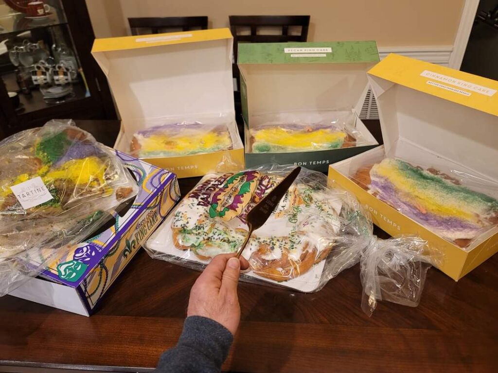 A variety of New Orleans King Cakes from different bakeries including Manny Randazzo, Tartine, and Bon Temps, illustrating brand loyalty and Team Randazzo vs Team Dong Phuong debates during Carnival season.