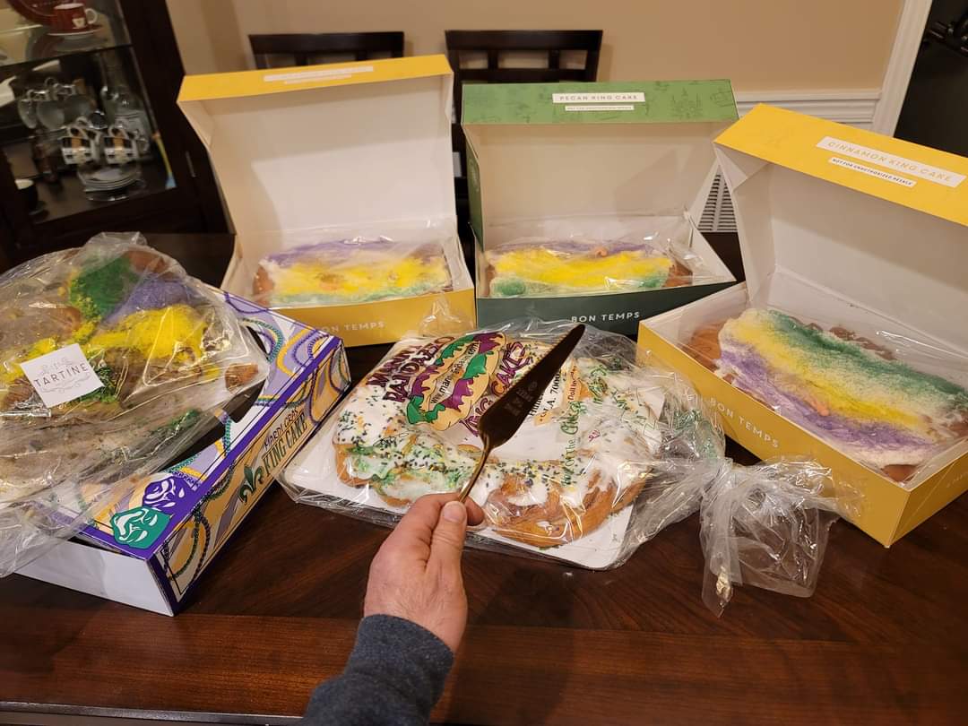 A variety of New Orleans King Cakes from different bakeries including Manny Randazzo, Tartine, and Bon Temps, illustrating brand loyalty and Team Randazzo vs Team Dong Phuong debates during Carnival season.